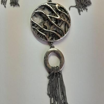 Necklace with matching earrings White and black with silver color design.