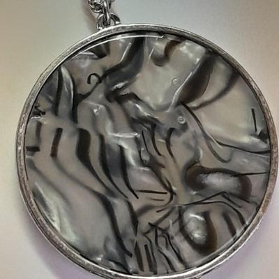 Necklace with matching earrings White and black with silver color design.