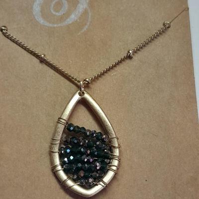 Two necklaces - Plunder and silver toned pendant with chains.