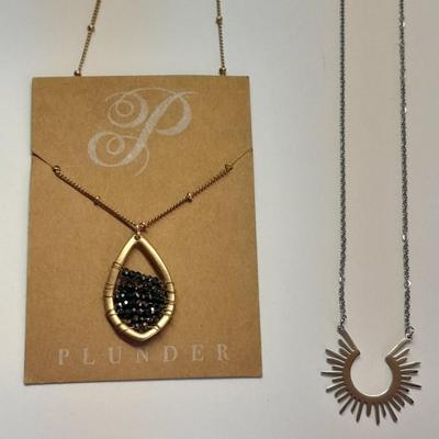 Two necklaces - Plunder and silver toned pendant with chains.