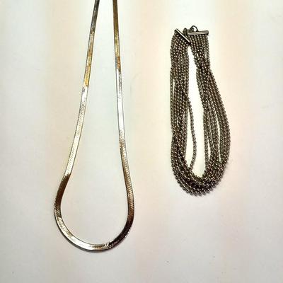Two fun and fancy silver toned necklaces - chains