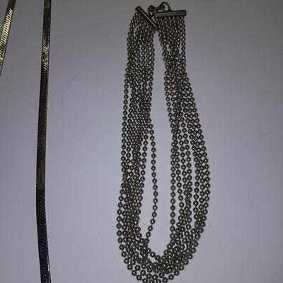 Two fun and fancy silver toned necklaces - chains