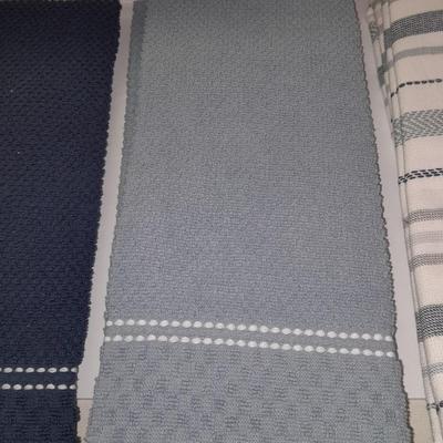 Four wooden bamboo lidded plastic food storage containers with an assortment of Kitchen hand towels