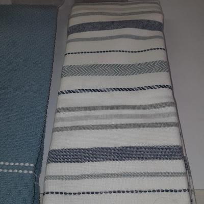 Four wooden bamboo lidded plastic food storage containers with an assortment of Kitchen hand towels