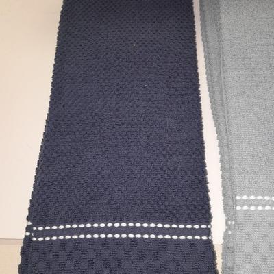 Four wooden bamboo lidded plastic food storage containers with an assortment of Kitchen hand towels