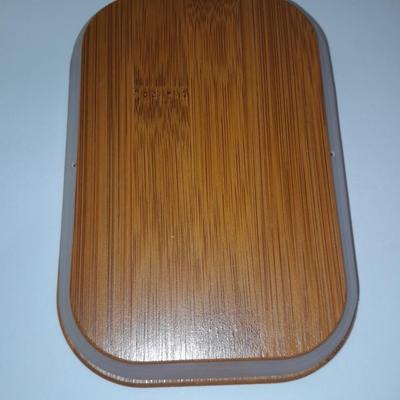 Four wooden bamboo lidded plastic food storage containers with an assortment of Kitchen hand towels