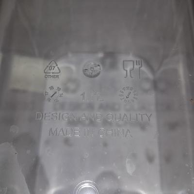 Four wooden bamboo lidded plastic food storage containers with an assortment of Kitchen hand towels