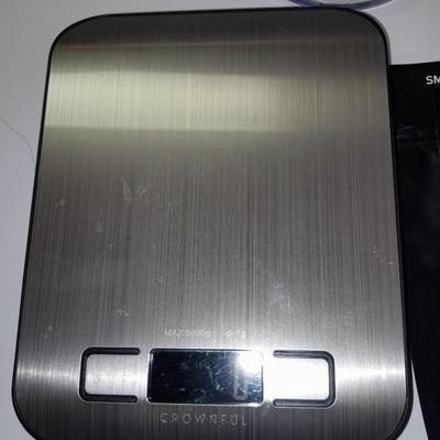 Digital food scale - POM Gear Phone charger - and a few smart stash brand bags.