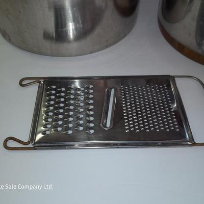 Rever ware stainless pot with larger stock pot and a metal bowl-hung cheese grater