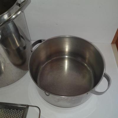 Rever ware stainless pot with larger stock pot and a metal bowl-hung cheese grater