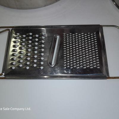 Rever ware stainless pot with larger stock pot and a metal bowl-hung cheese grater