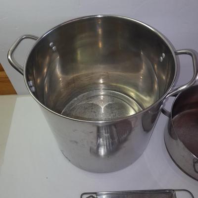 Rever ware stainless pot with larger stock pot and a metal bowl-hung cheese grater