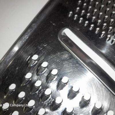 Rever ware stainless pot with larger stock pot and a metal bowl-hung cheese grater