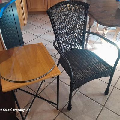 Metal framed end table with wood or glass top and a black woven plastic armchair
