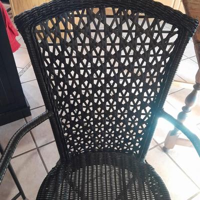 Metal framed end table with wood or glass top and a black woven plastic armchair