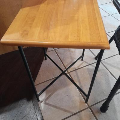 Metal framed end table with wood or glass top and a black woven plastic armchair