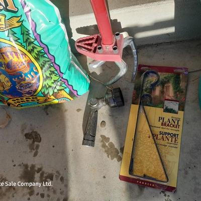 Rope handled barrel with new Fox farm potting soil, weed claw, and other gardening items