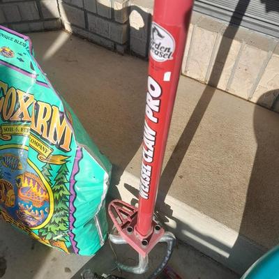 Rope handled barrel with new Fox farm potting soil, weed claw, and other gardening items