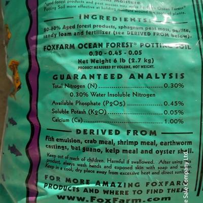 Rope handled barrel with new Fox farm potting soil, weed claw, and other gardening items