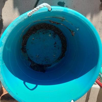 Rope handled barrel with new Fox farm potting soil, weed claw, and other gardening items