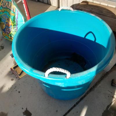 Rope handled barrel with new Fox farm potting soil, weed claw, and other gardening items