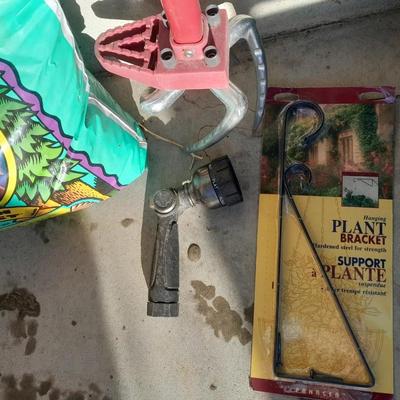 Rope handled barrel with new Fox farm potting soil, weed claw, and other gardening items