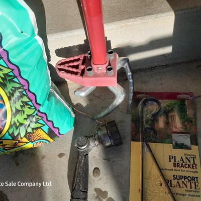 Rope handled barrel with new Fox farm potting soil, weed claw, and other gardening items