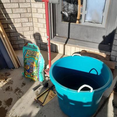 Rope handled barrel with new Fox farm potting soil, weed claw, and other gardening items