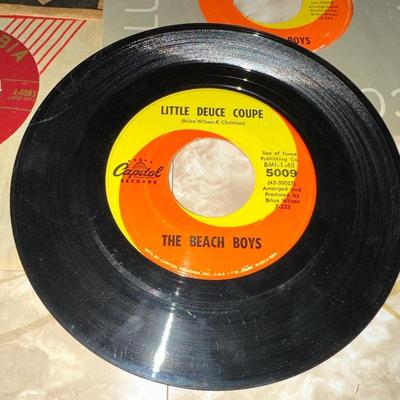 A COLLECTION OF 45's RECORDS INCLUDING ELVIS AND THE BEACH BOYS