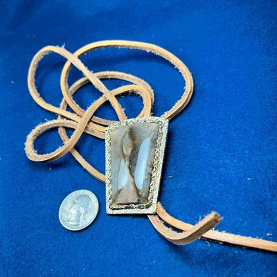 LARGE POLISHED STONE WITH REAL RAWHIDE STRINGS BOLO TIE