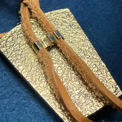 LARGE POLISHED STONE WITH REAL RAWHIDE STRINGS BOLO TIE