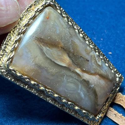 LARGE POLISHED STONE WITH REAL RAWHIDE STRINGS BOLO TIE