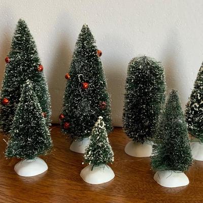 Three medium trees, one bush,, and two small trees