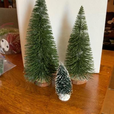 Two tall, one medium Christmas trees
