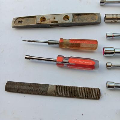 Assortment of Nut drivers with a level and a rasp