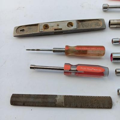 Assortment of Nut drivers with a level and a rasp