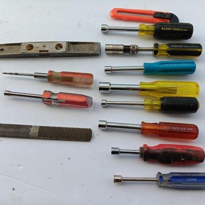 Assortment of Nut drivers with a level and a rasp