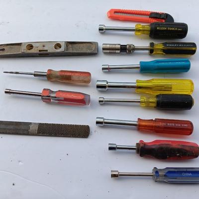 Assortment of Nut drivers with a level and a rasp