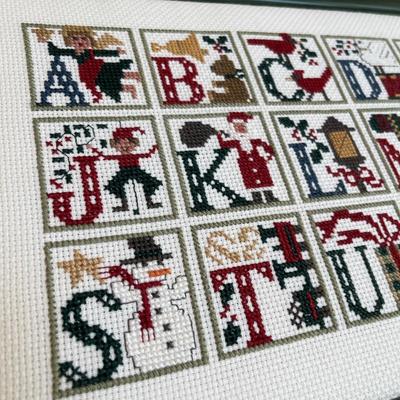 2 framed cross stitch pictures.