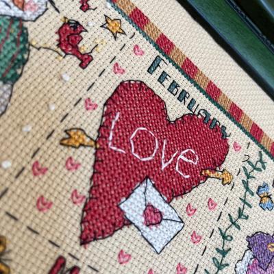 2 framed cross stitch pictures.