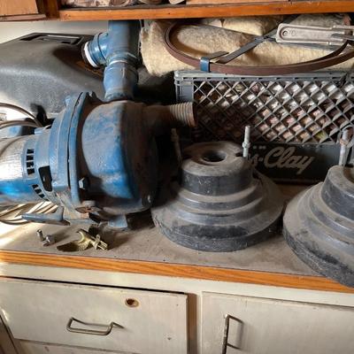 Some kind of pump and cass clay crate with rags