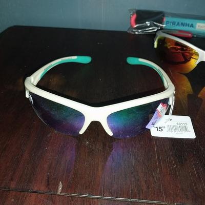 TWO NEW SUNGLASSES WITH TAGS AND PIRANHA CORD