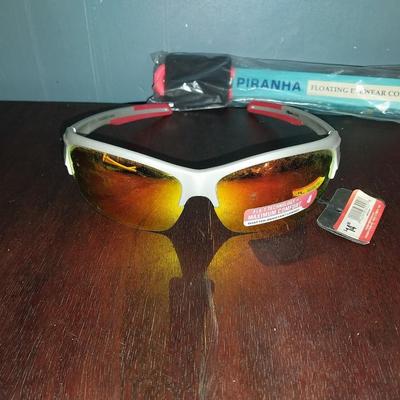 TWO NEW SUNGLASSES WITH TAGS AND PIRANHA CORD