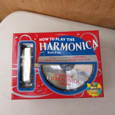 HARMONICA IN BOX AND PAINTED BRASS BELL