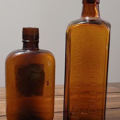 (2) Brown Antique Bottles - Liquor Flask & Bitters Bottles