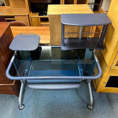 BLUE TONED GLASS TOP DESK WITH METAL FRAME AND BLUE UPHOLSTERED CHAIR
