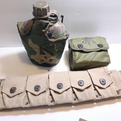 Military issued pouches and bags Ammunition with a canteen and first aid kit.