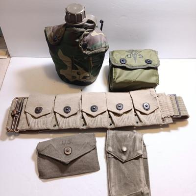 Military issued pouches and bags Ammunition with a canteen and first aid kit.