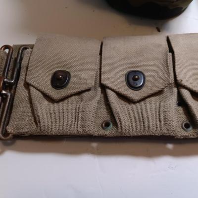 Military issued pouches and bags Ammunition with a canteen and first aid kit.