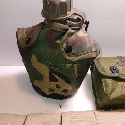Military issued pouches and bags Ammunition with a canteen and first aid kit.